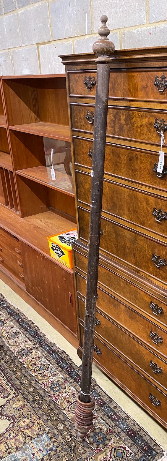 A Victorian curtain pole with assorted rings, length 181cms.